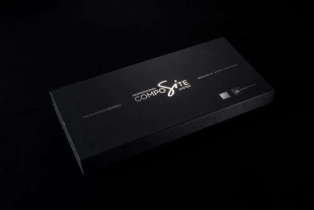 Black linen-effect rigid box with silver foil-blocked branding for a dental instrument kit