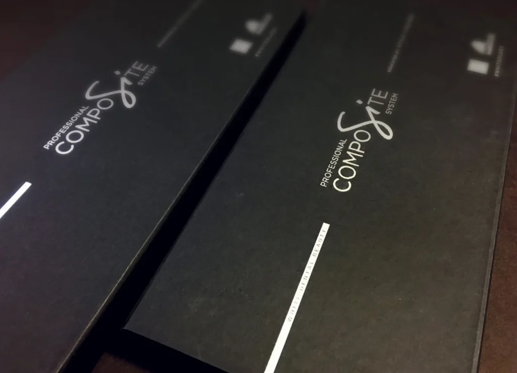 Close-up of two-colour foil blocking on a black linen-effect box covering